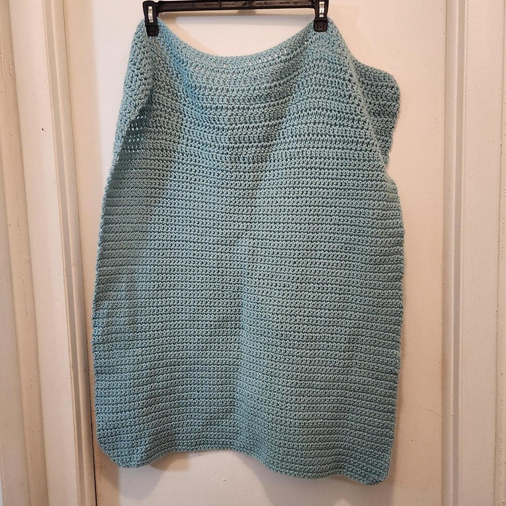 Handmade crochet baby blanket in a soft light blue/aqua shade
